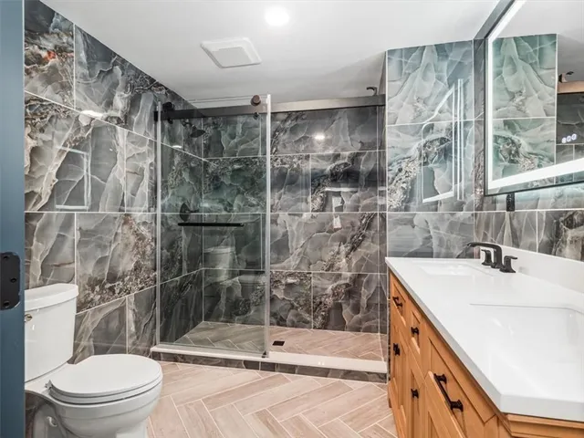 a bathroom with a sink toilet and shower