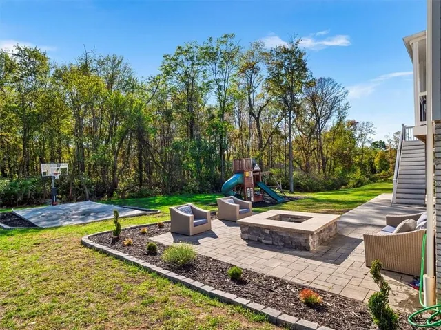 a view of a backyard with plants and patio