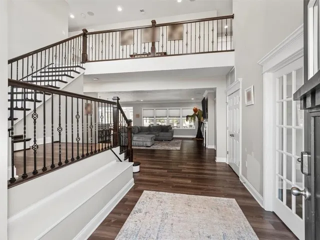 a view of staircase with lots of wooden floor and a rug