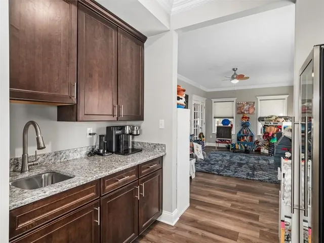 a kitchen with stainless steel appliances granite countertop a sink refrigerator and cabinets
