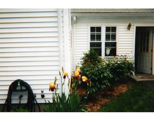 32 Evergreen Road Natick, MA 01760 - Photo 5 of 24 a backyard of a house with wooden fence and a bench