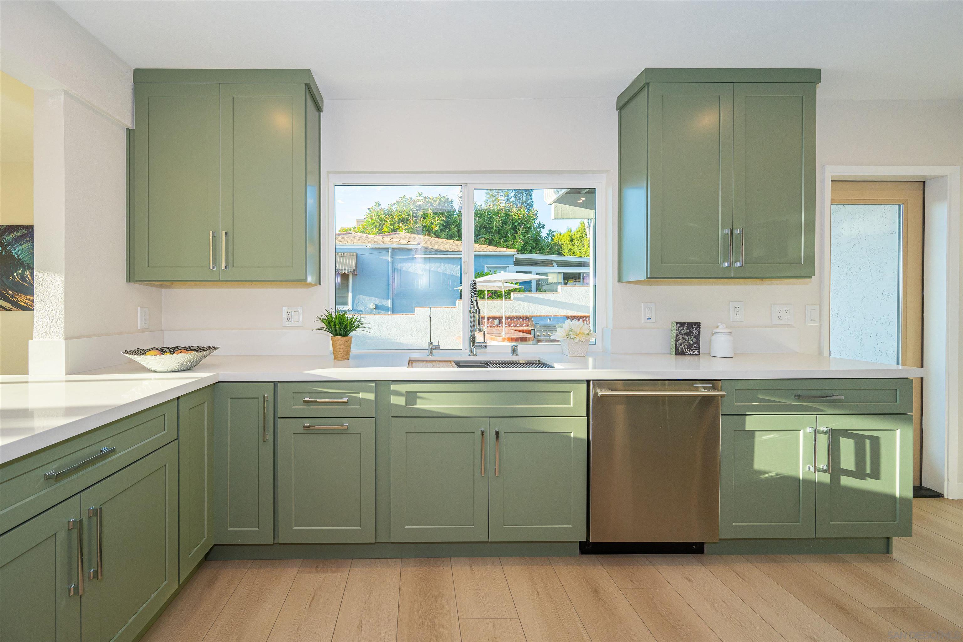 1360 Elevation Road San Diego, CA 92110 - Photo 14 of 37 a kitchen with a sink and wooden cabinets