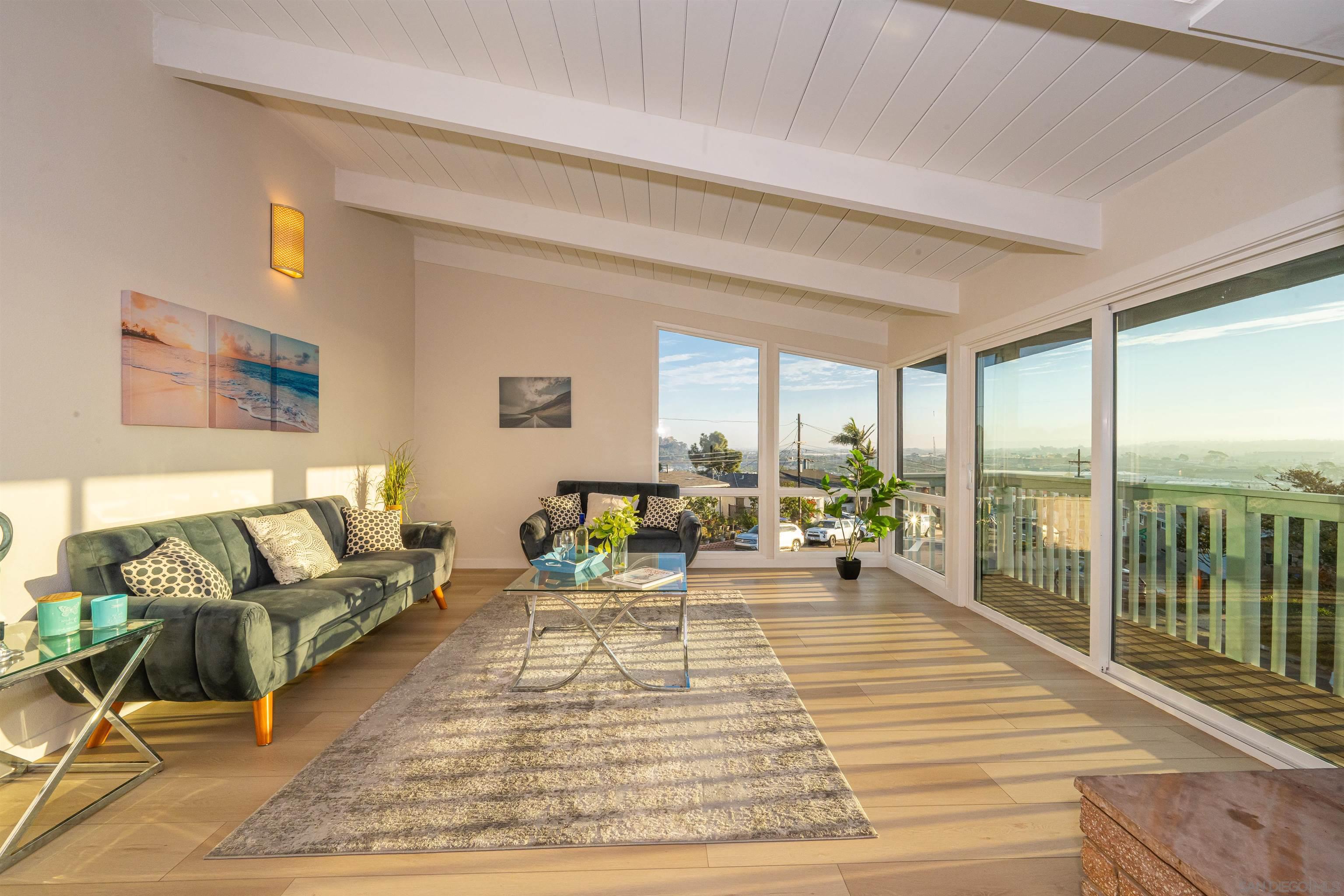 1360 Elevation Road San Diego, CA 92110 - Photo 16 of 37 a living room with furniture and floor to ceiling windows