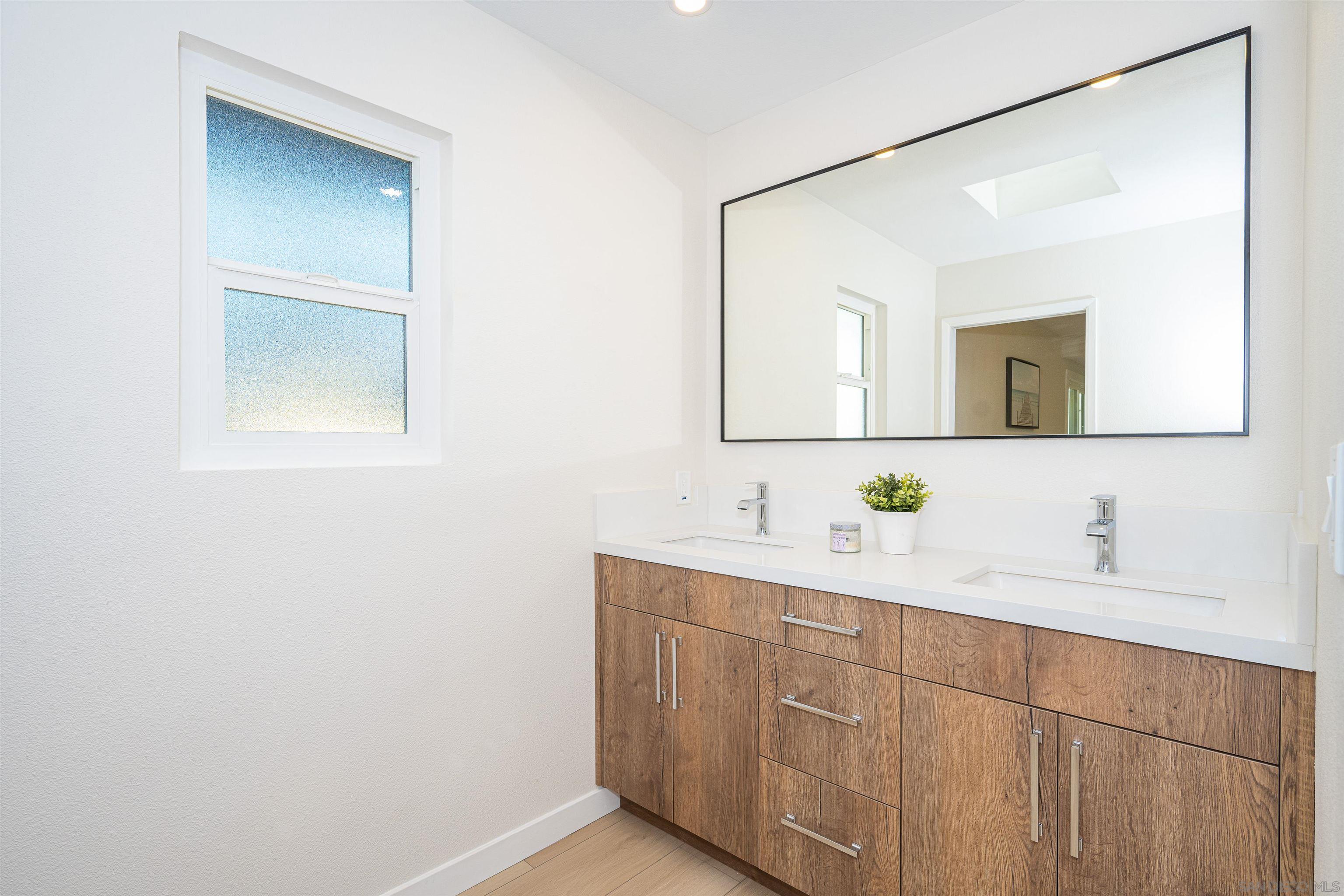 1360 Elevation Road San Diego, CA 92110 - Photo 25 of 37 a bathroom with a double vanity sink and mirror