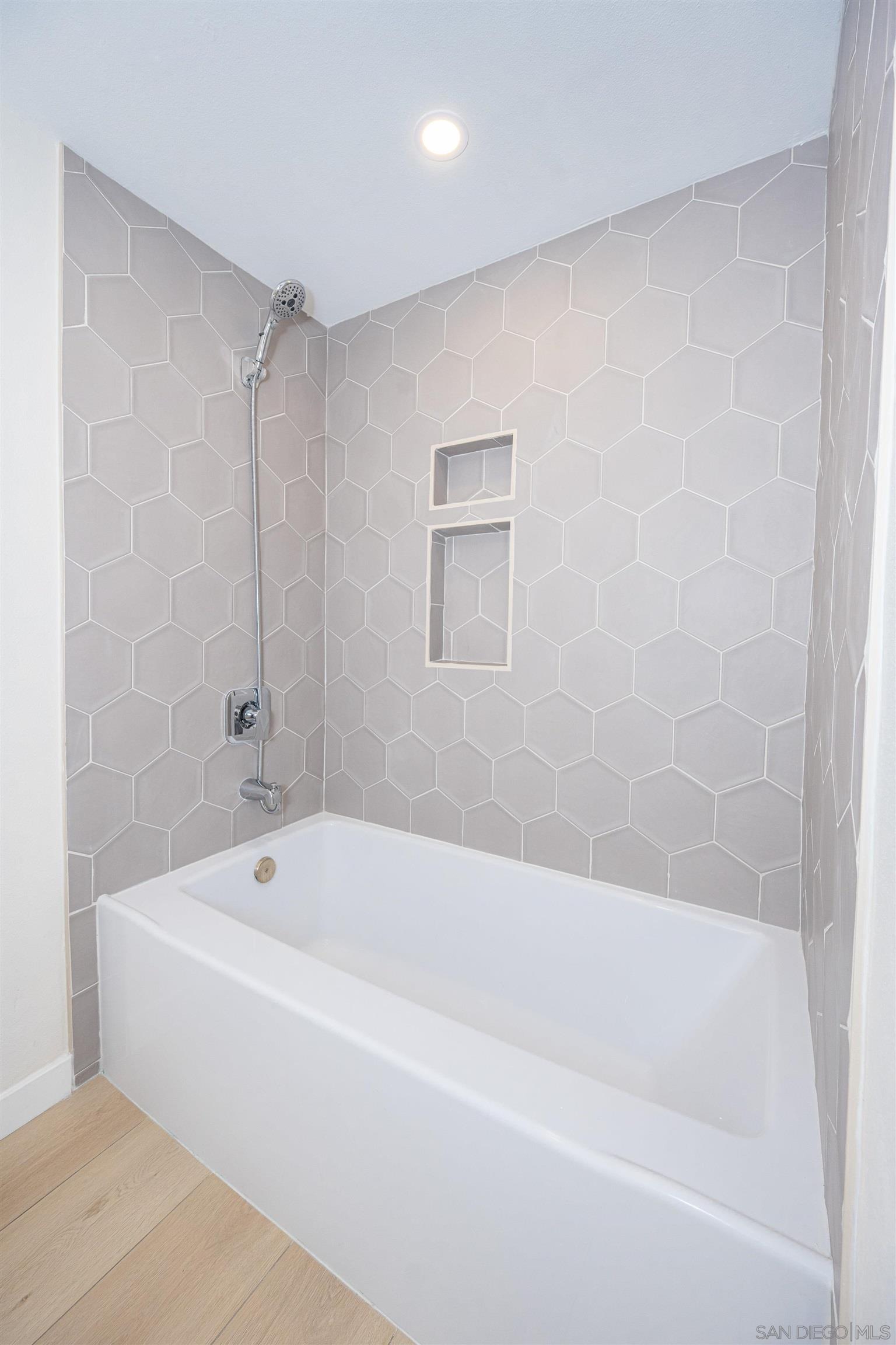 1360 Elevation Road San Diego, CA 92110 - Photo 28 of 37 a white bath tub sitting next to a white sink and vanity