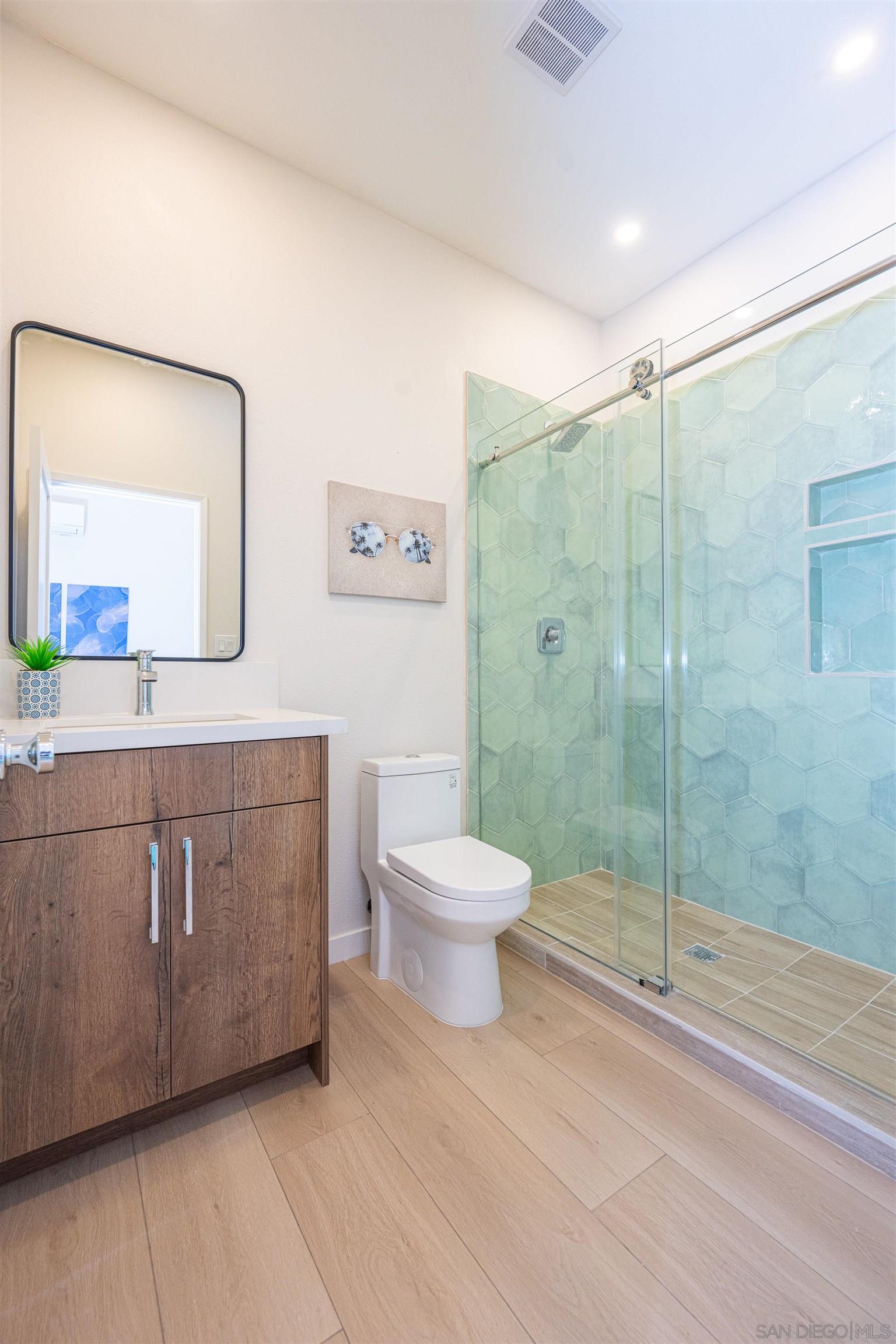 1360 Elevation Road San Diego, CA 92110 - Photo 36 of 37 a bathroom with a toilet a sink and mirror