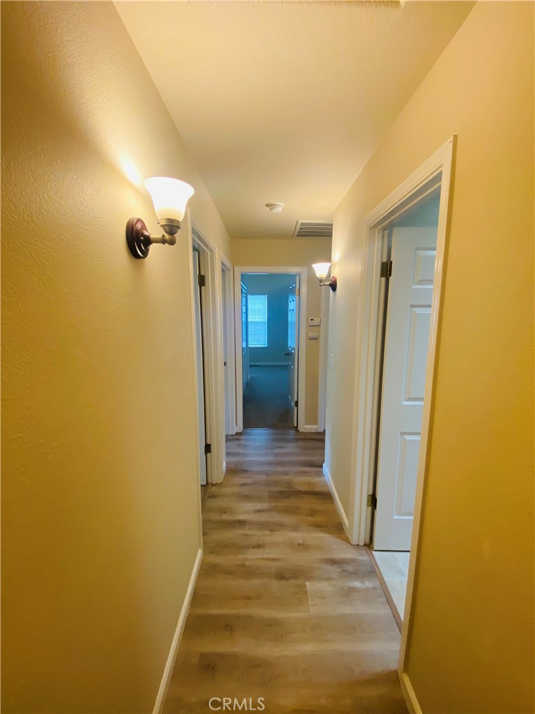 16506 Ridgecrest Court Hidden Valley Lake, CA 95467 - Photo 14 of 25 a view of a hallway with wooden shelves