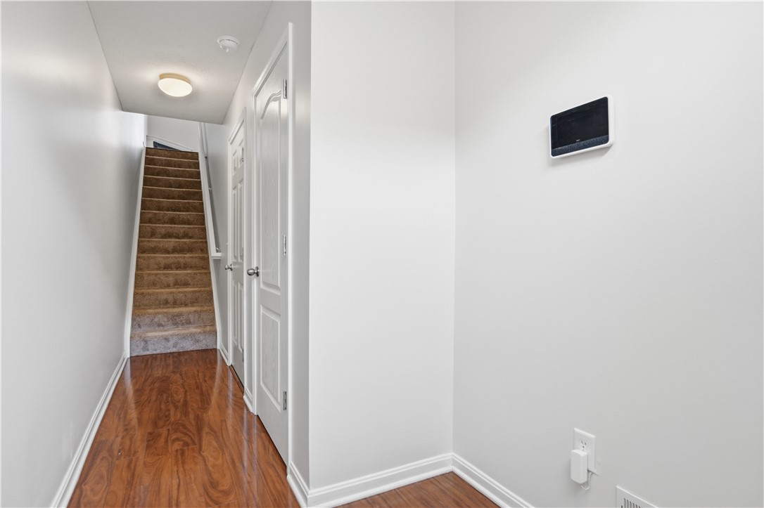 4294 Straight Arrow Road Dayton, OH 45430 - Photo 6 of 41 This inviting hallway features rich hardwood flooring leading to a carpeted staircase.
