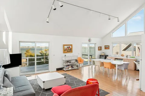 a living room with furniture large window and livingroom