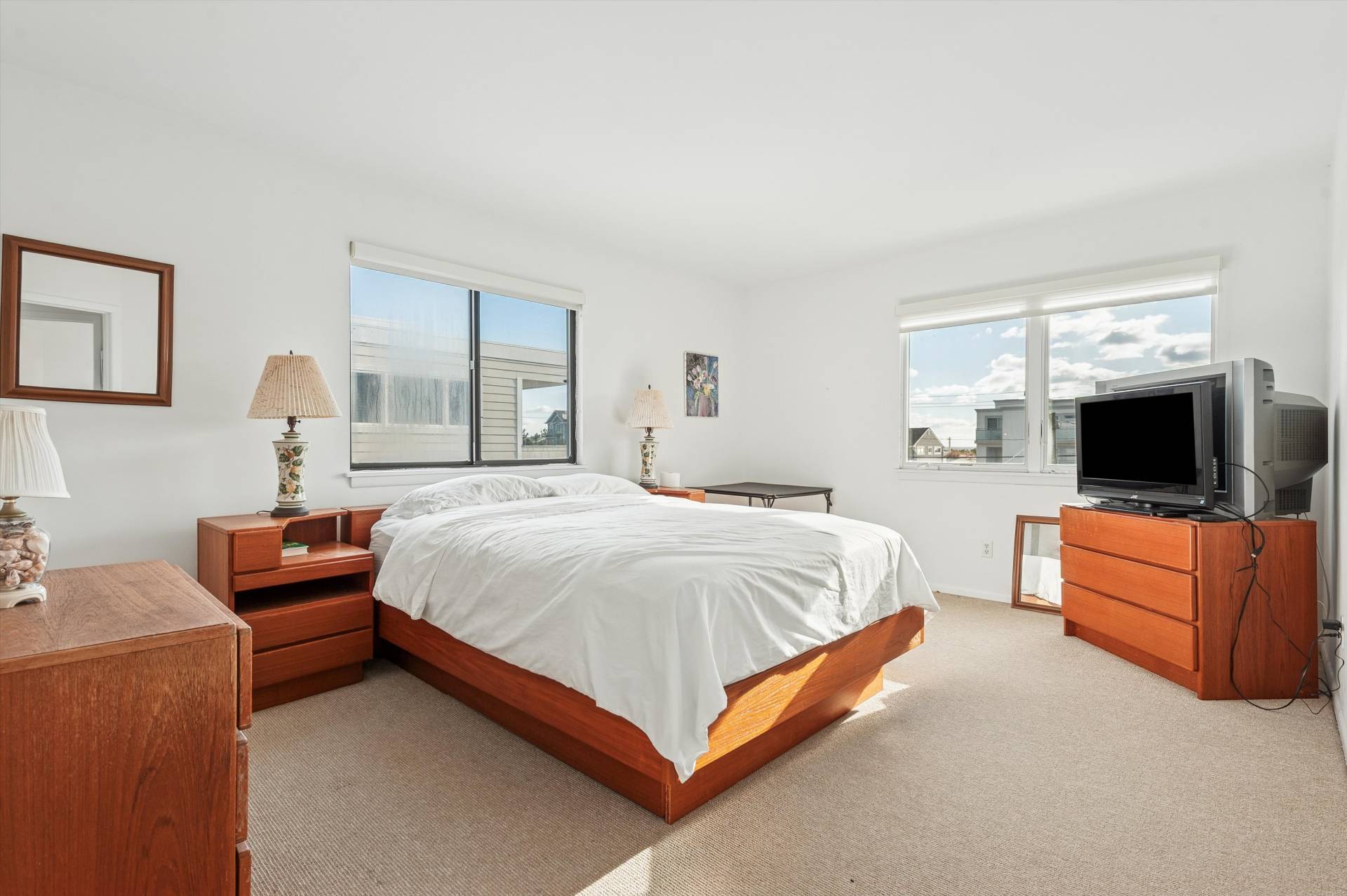 630 Dune Road Westhampton, NY 11978 - Photo 6 of 14 a spacious bedroom with a bed and a couch