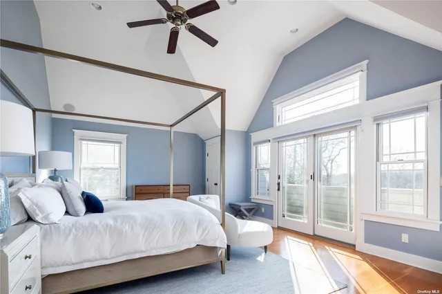 a bedroom with a large bed and a large window