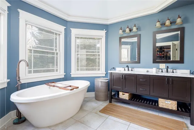 a bathroom with a bathtub a sink and a window