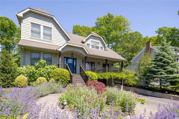 a front view of house with a garden