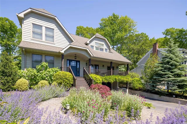 a front view of house with a garden