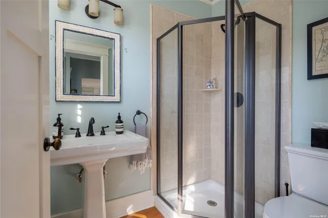 a bathroom with a sink mirror and shower