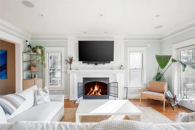 a living room with furniture a flat screen tv and a fireplace
