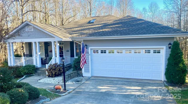 a front view of a house with a yard and fountain in middle