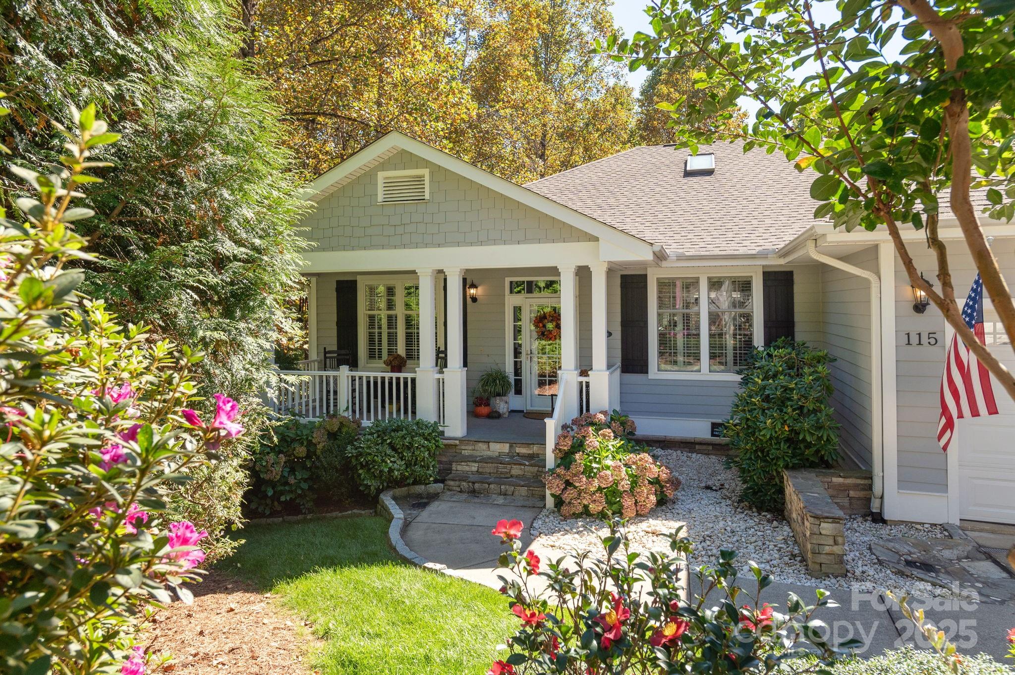 115 Chancery Court Flat Rock, NC 28731 - Photo 2 of 47 a front view of a house with a yard and fountain in middle