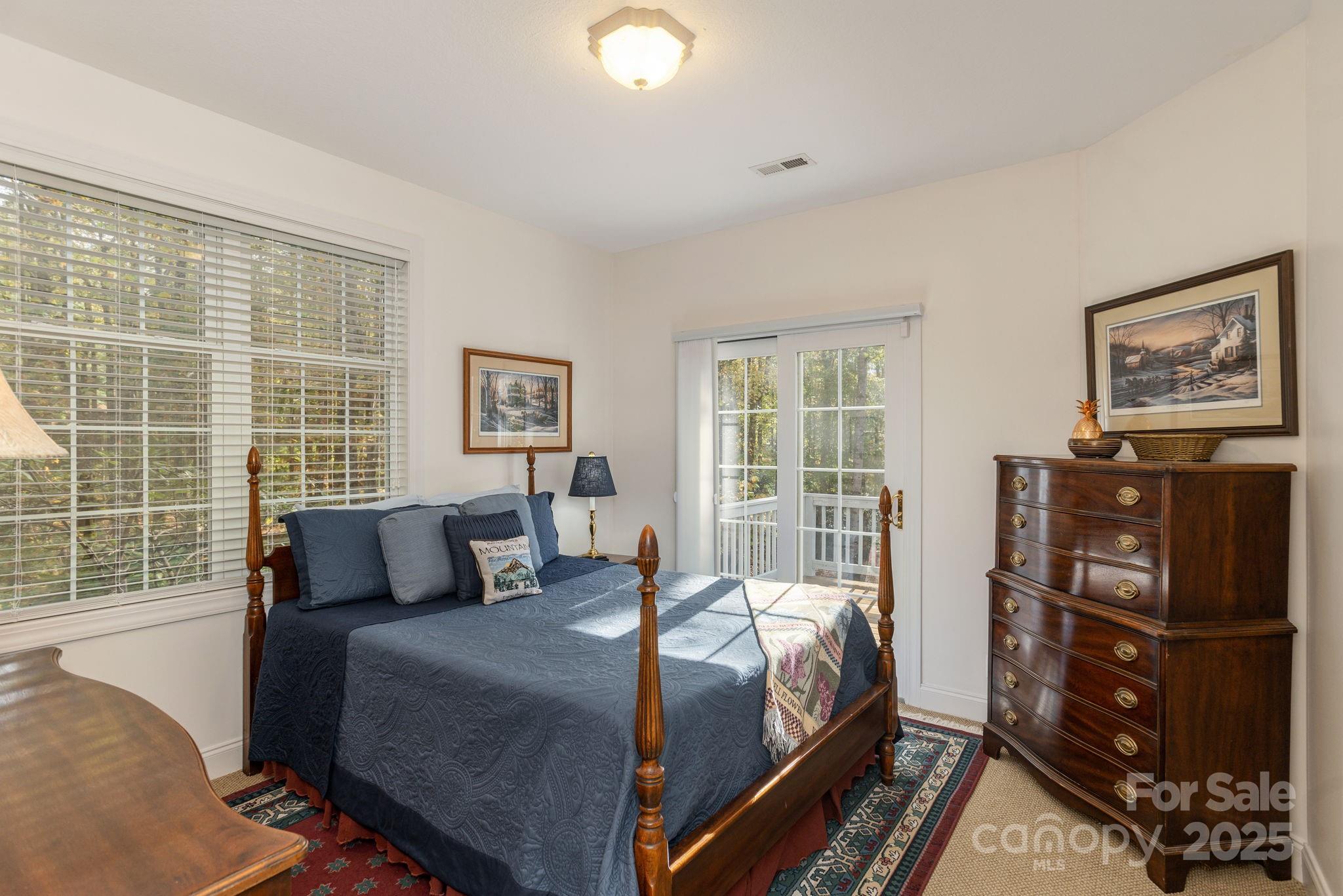 115 Chancery Court Flat Rock, NC 28731 - Photo 30 of 47 a bedroom with a bed and wooden floor