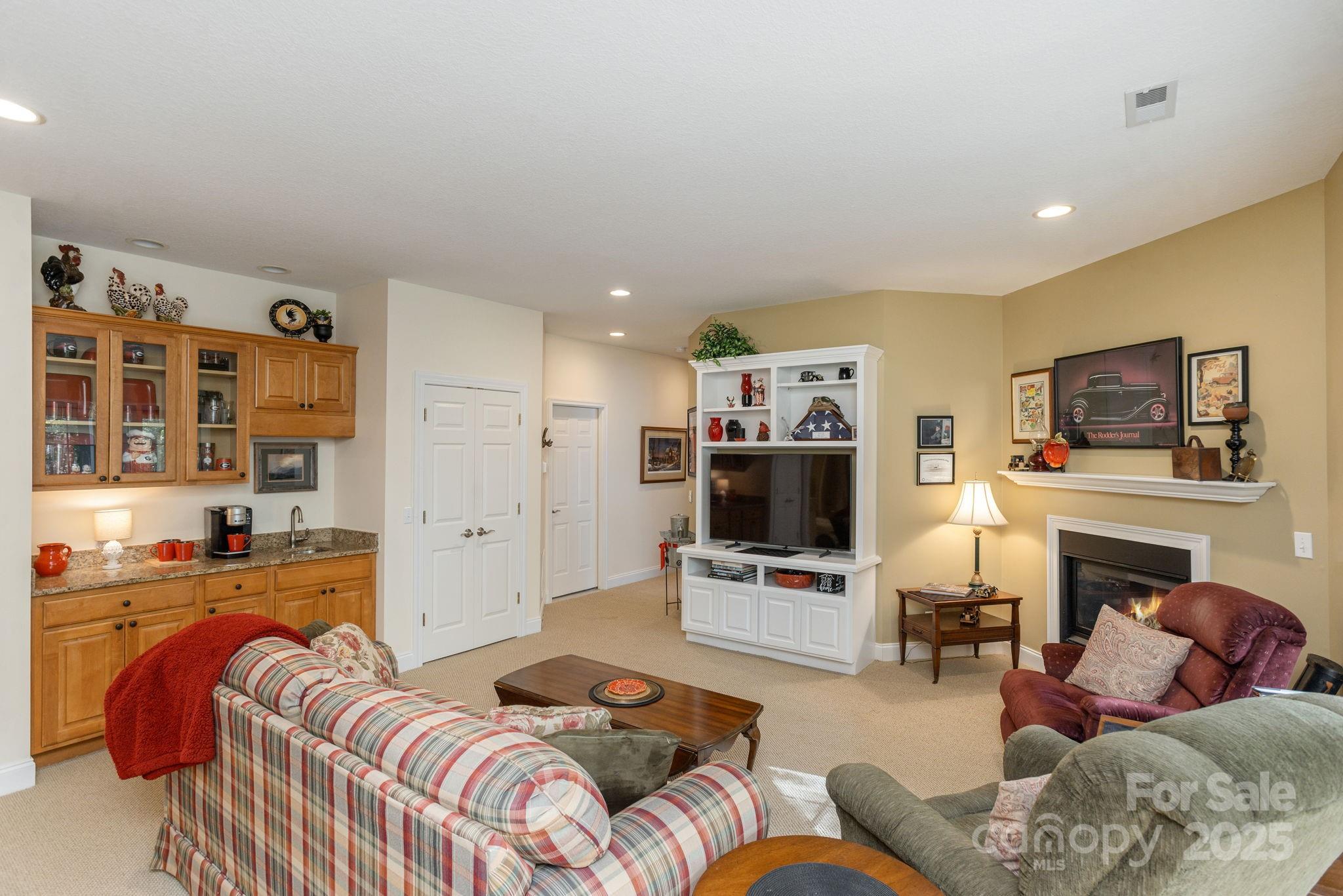 115 Chancery Court Flat Rock, NC 28731 - Photo 34 of 47 a living room with furniture flat screen tv and a fireplace