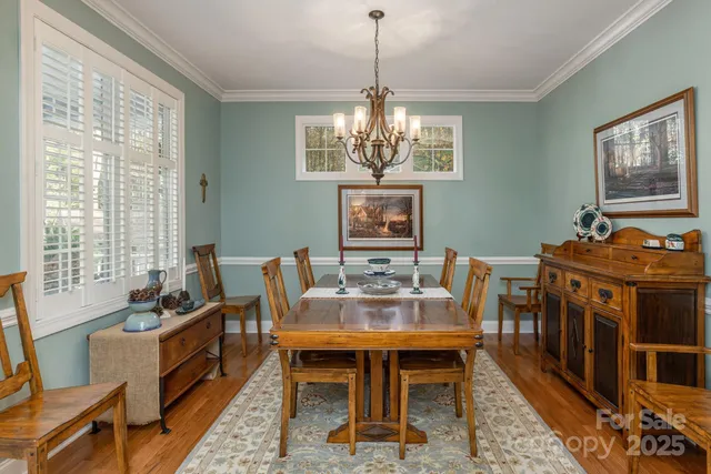 a living room with furniture large window and a wooden floor