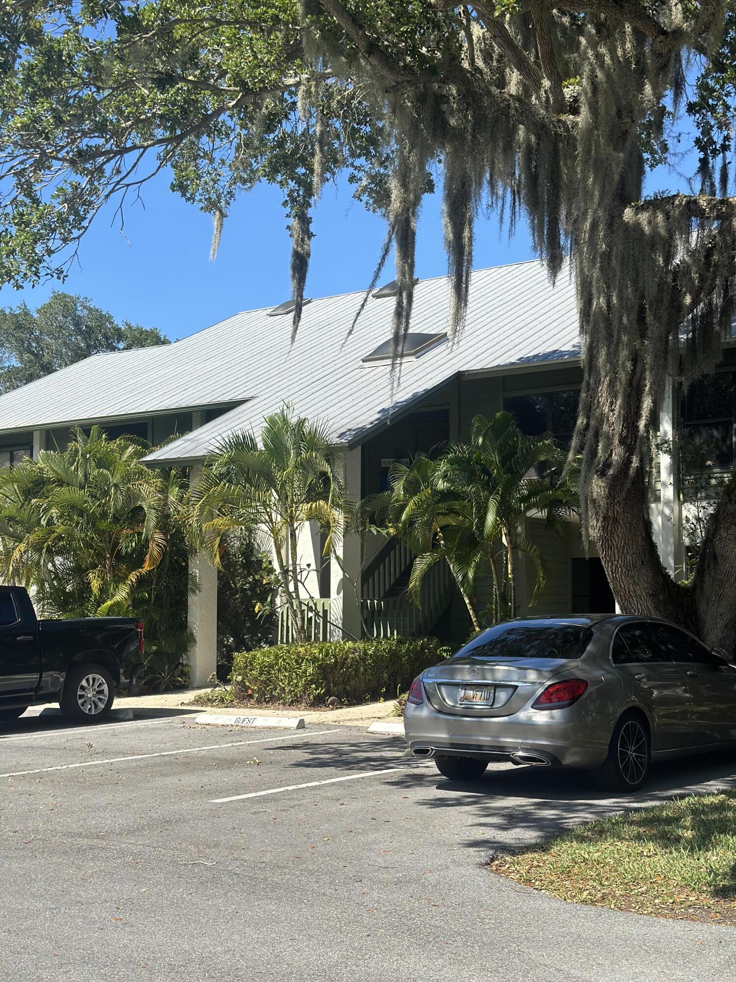 5270 Southeast Seascape Way, Unit 102 Stuart, FL 34997 - Photo 1 of 24 front view of a house with a yard