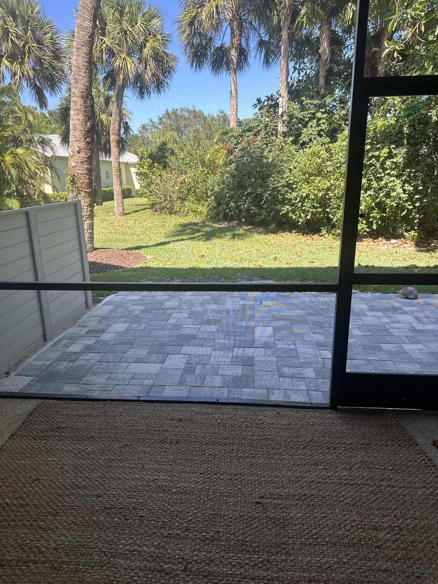 5270 Southeast Seascape Way, Unit 102 Stuart, FL 34997 - Photo 17 of 24 a view of a yard with a large tree