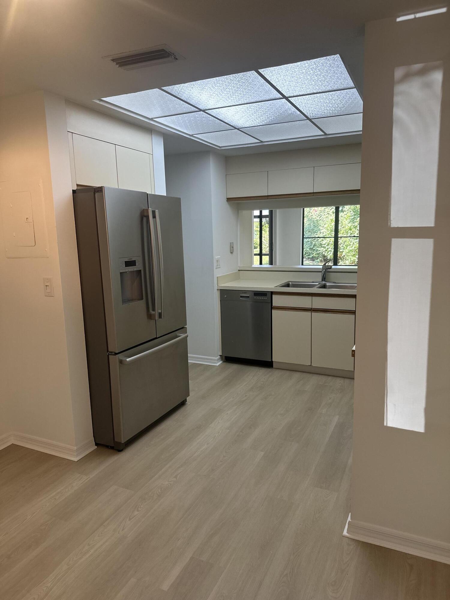 5270 Southeast Seascape Way, Unit 102 Stuart, FL 34997 - Photo 7 of 24 a kitchen with refrigerator and window
