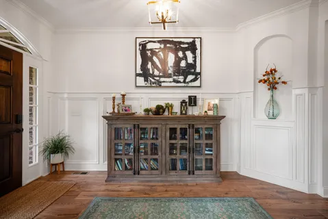 a kitchen with a dining table chairs sink and cabinets
