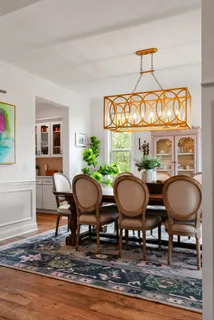 a living room with furniture a fireplace and a chandelier