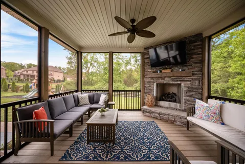 a living room filled with furniture chandelier and a rug