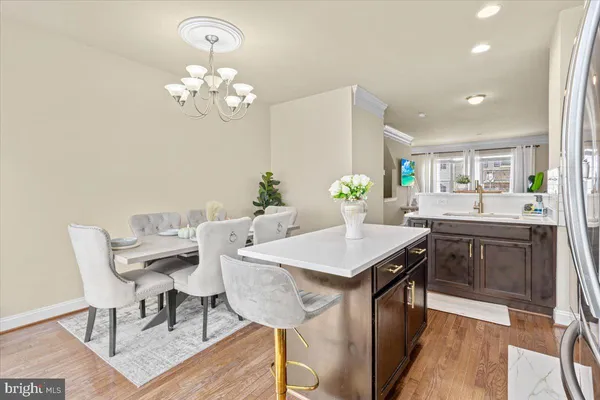 a view of a dining room with furniture and chandelier