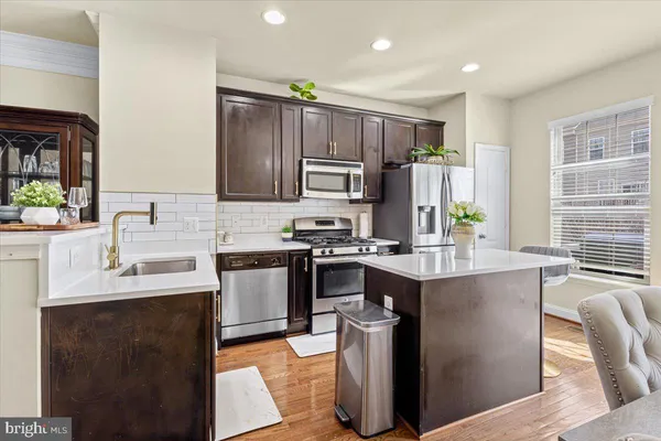 a kitchen with a sink stove and refrigerator
