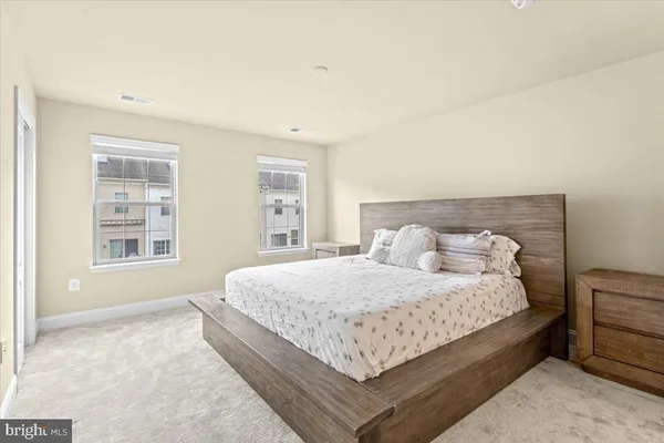 a bedroom with a bed lamp closet and window