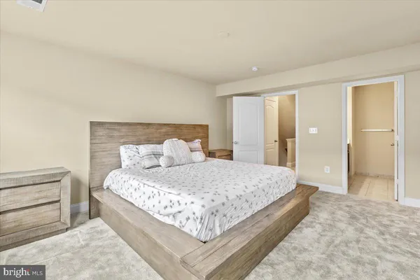 a bedroom with a large bed and walk in closet