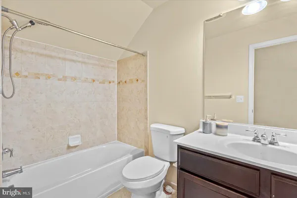 a bathroom with a sink toilet vanity and shower