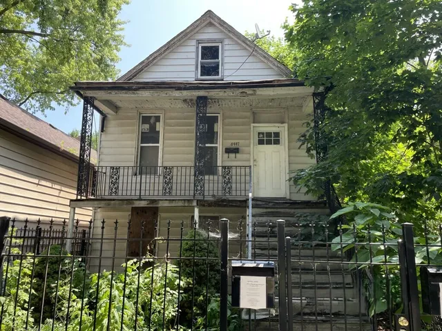 a view of a house with wooden fence