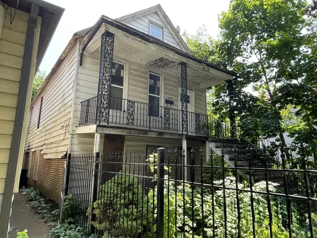 a front view of a house with plants