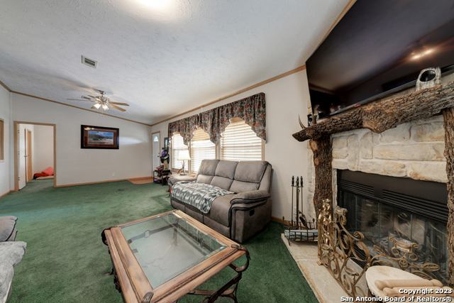 649 Rocky Hill Road Junction, TX 76849 - Photo 11 of 51 a living room with furniture and a fireplace