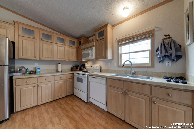 649 Rocky Hill Road Junction, TX 76849 - Photo 13 of 51 a kitchen with sink cabinets and window