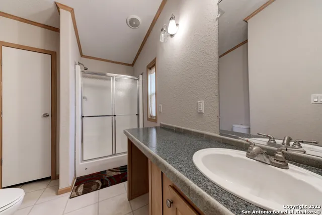 a bedroom with two beds and a window