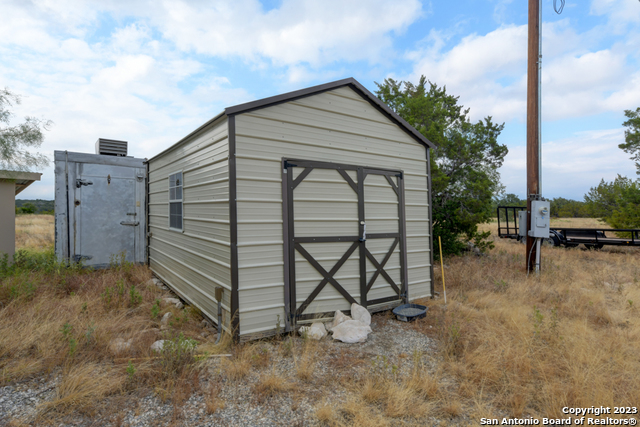649 Rocky Hill Road Junction, TX 76849 - Photo 20 of 51 a view of a house with backyard and deck