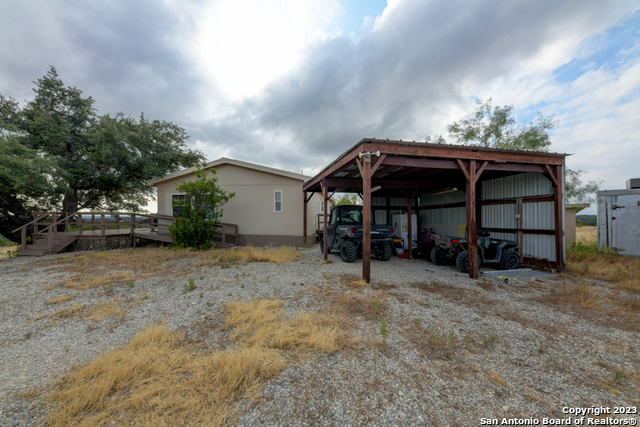 649 Rocky Hill Road Junction, TX 76849 - Photo 21 of 51 a view of a house with a yard and sitting area