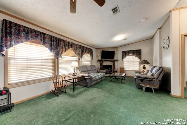 a living room with furniture fireplace and a flat screen tv