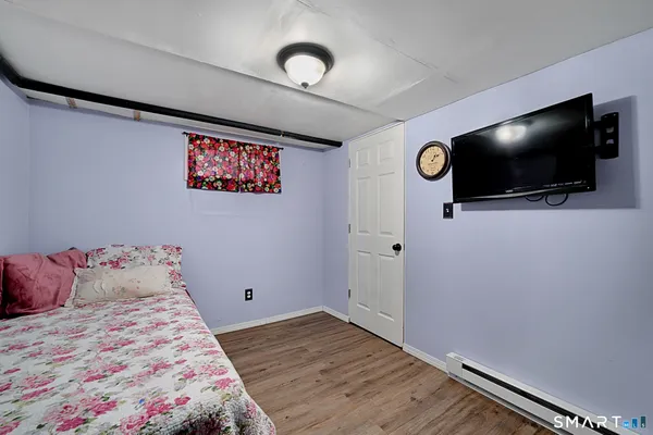 a bedroom with a bed and a flat screen tv