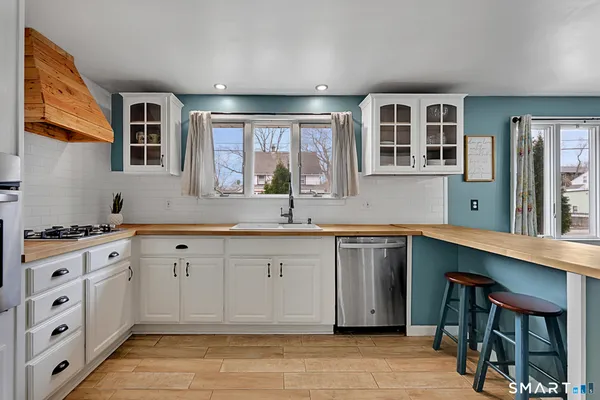 a kitchen with stainless steel appliances granite countertop a stove and cabinets