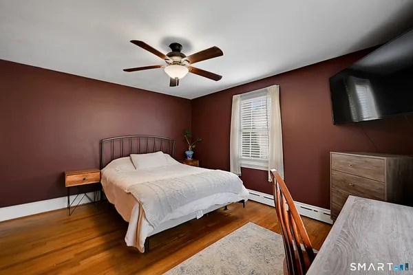 a bedroom with a bed and a ceiling fan