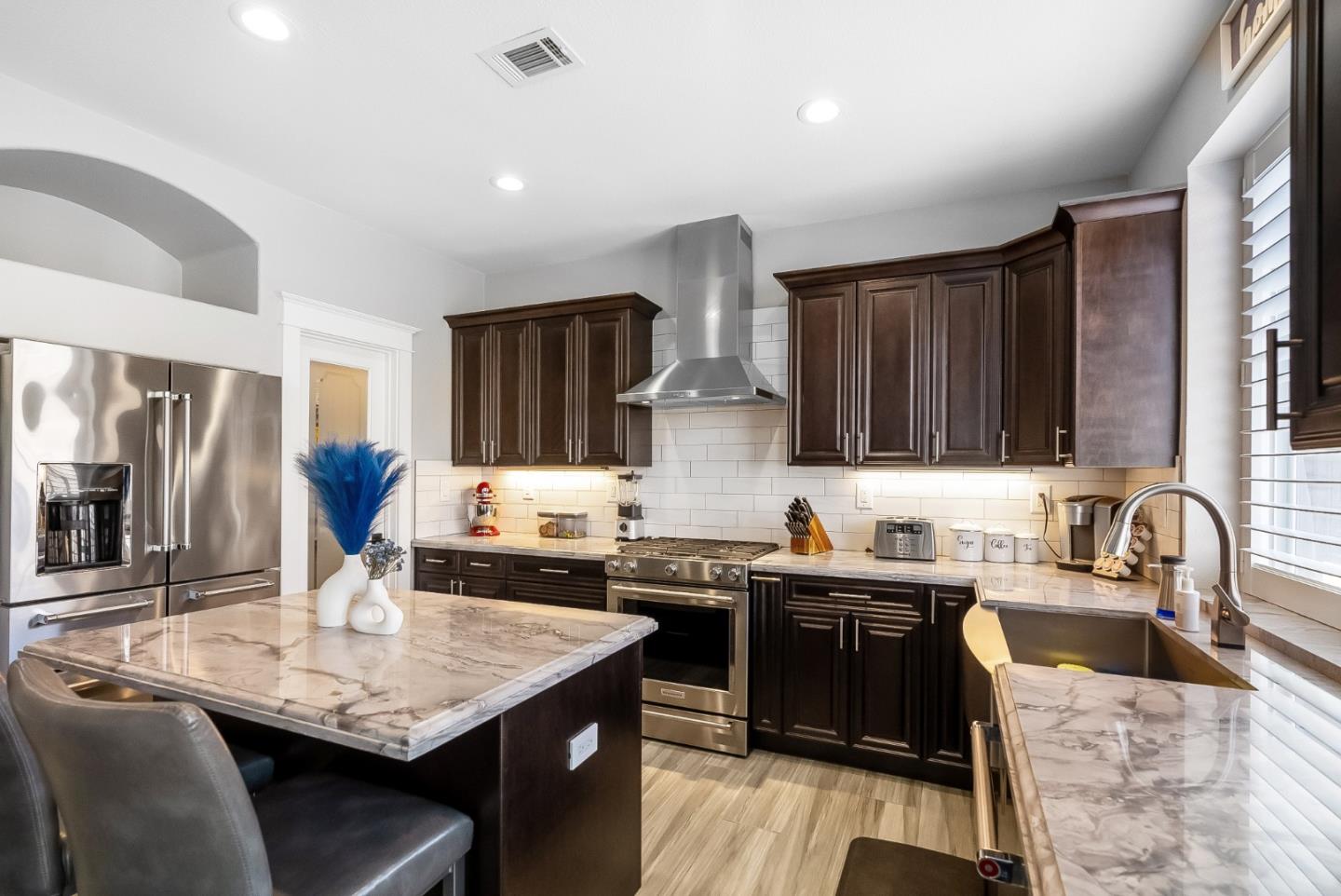 1170 Schoolhouse Road San Jose, CA 95138 - Photo 11 of 35 a kitchen with granite countertop a sink and cabinets
