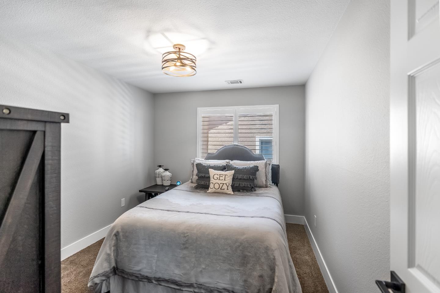 1170 Schoolhouse Road San Jose, CA 95138 - Photo 22 of 35 a bedroom with a bed and a chandelier