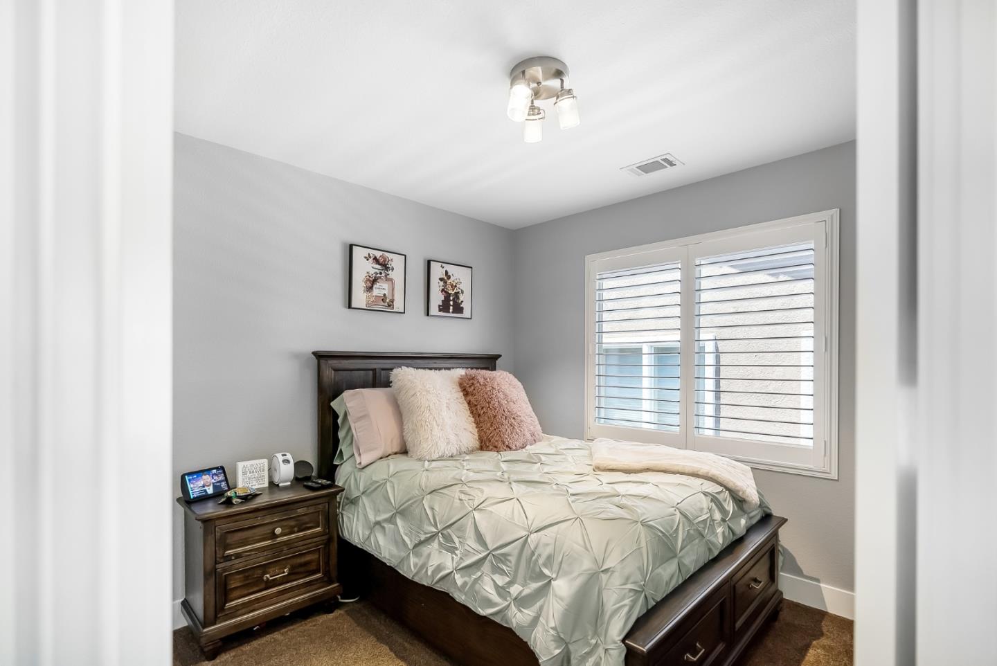 1170 Schoolhouse Road San Jose, CA 95138 - Photo 23 of 35 a bedroom with a bed and a chandelier